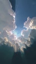 Towering cumulus clouds fill the sky, illuminated by diffuse sunlight creating