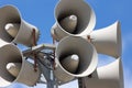 A Towering Ensemble of Elegant White Speakers Perched on a Metallic Pole