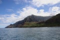 Towering, eroding cliffs and a deep valley of the Napali Shoreline contrasting against the Pacific Ocean