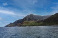 Towering, eroding cliffs and a deep valley of the Napali Shoreline contrasting against the Pacific Ocean