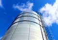 Towering grain silo under blue skies. Royalty Free Stock Photo