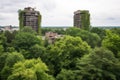 towering mature trees and green rooftops in park setting