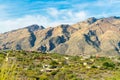 Towering moutains with desert mansion community in the deserts of arizona in a rural neighborhood with native cactuses