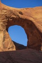 Towering sand stone buttes with a arch hole int the rock at Monument Valley in the Arizona and Utah border of the southwest USA