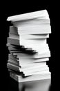 A Towering Stack of Blank Paper Sheets Displaying Clean Edges and Textured Surfaces, Captured Against a Smooth Black Background Royalty Free Stock Photo