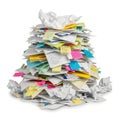 A towering stack of crumpled papers and colorful sticky notes in a chaotic pile isolated on white background Royalty Free Stock Photo