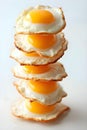 A towering stack of fried eggs with bright yolks