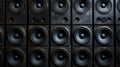 A towering stack of professional loudspeakers, arranged in a grid pattern