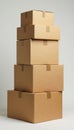 A towering stack of used cardboard boxes ready for recycling , light, dented