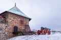 Towers of Akershus castle in Oslo. Cannon on the embankment, tower from brick visible. Cloudy weather in winter, snow lying around Royalty Free Stock Photo