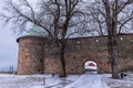 Towers of Akershus castle in Oslo. Cannon on the embankment, tower from brick visible. Cloudy weather in winter, snow lying around Royalty Free Stock Photo