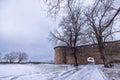 Towers of Akershus castle in Oslo. Cannon on the embankment, tower from brick visible. Cloudy weather in winter, snow lying around Royalty Free Stock Photo