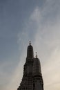 The towers of the Buddhist temple Wat Arun against the evening sky in Bangkok Royalty Free Stock Photo