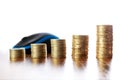 Towers of coins on wooden table in front of computer mouse Royalty Free Stock Photo