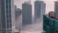 Rare early morning winter fog above the Dubai Marina skyline and skyscrapers rooftops aerial timelapse. Royalty Free Stock Photo