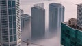 Rare early morning winter fog above the Dubai Marina skyline and skyscrapers rooftops aerial timelapse. Royalty Free Stock Photo