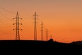 Towers of electricity over mountains at sunset Royalty Free Stock Photo