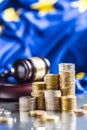 Towers with euro coins flag of European Union and justice hammer in the background Royalty Free Stock Photo