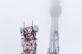 Towers 5g against a gloomy gray sky in fog. Modern technologies