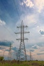 Towers of high-voltage power lines, against the background of clouds Royalty Free Stock Photo