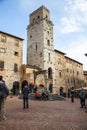 Towers and medieval well on Piazza della Cisterna in San Gimignano in tuscany in italy Royalty Free Stock Photo