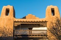 Towers of an old pueblo style adobe building with rustic, ornate wood beams and balcony in Santa Fe, New Mexico Royalty Free Stock Photo