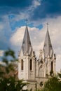 Towers and roof of St. Anna Roman Catholic Church, Christian temple in Neo Gothic style, detail telephoto against cloudy sky Royalty Free Stock Photo