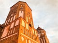 Towers and spiers of a high medieval stone old ancient beautiful castle against a blue sky