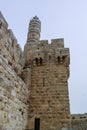 Towers and walls of Jerusalem citadel and Tower of David in sandstorm.