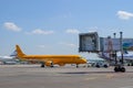 Towing an orange Embraer ERJ-195 with tail number VQ-BRX of Saratov Airlines on the apron of Domodedovo airport