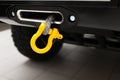 A towing winch with a clevis and a loop on a metal cable mounted on a car for pulling out and evacuating vehicles. Overcoming off-