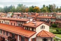 Town architecture of the brown roof townhouse with windows autumn forest background