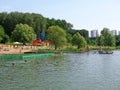 Town beach with forest in sunny weather.