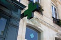 Town green cross Pharmacy sign in street Royalty Free Stock Photo