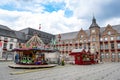 Town Hall Dusseldorf, Germany with carrousel, and stalls for sweets and ice. Small summer fair in pandemic times.