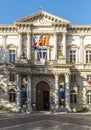 Town Hall in the french city of Avignon with flags and clock