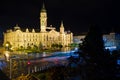 Town hall and square on a dark midnight after rain, blurred car lights on road, long exposure image of Gyor city Royalty Free Stock Photo