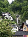 Town Hallstatt with mountain waterfall. Alpine massif, beautiful canyon in Austria.