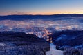Town Liberec with winter mountain forest before sunrise. Czech early morning snow landscape pink and violet light. Snowy trees wit Royalty Free Stock Photo