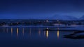 Town with lights and reflections in fjord, during Arctic night Royalty Free Stock Photo