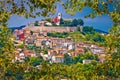 Town of Motovun on picturesque hill view through leaf frame