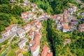 Town of Nesso on steep cliffs and creek waterfall gorge on Como Lake aerial view Royalty Free Stock Photo