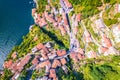 Town of Nesso on steep cliffs and creek waterfall gorge on Como Lake aerial view