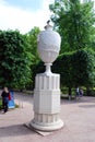Attractions of the Peterhof Museum-reserve. Sculpture `Vase` on the path in the garden.
