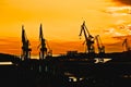 Town of Pula shipyard cranes sunset silhouette view Royalty Free Stock Photo