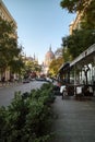 Town street with sidewalk cafe with view to Hungarian paliament building.