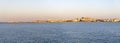 Town of Vieste and the lighthouse seen from the sea at sunset, Gargano Royalty Free Stock Photo