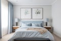 Townhouse double bedroom with a blue theme with bedside tables and lamps large window and two framed watercolour floral paintings Royalty Free Stock Photo