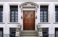 townhouse entrance with ornate stone design and elegant carved wooden front door