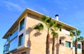 Townhouse Facade building near sea. Palm trees at Residential building.